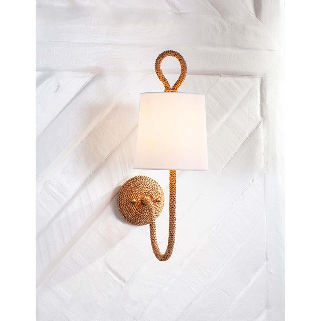 Natural woven rattan provides a "washed ashore" look on the Bimini sconce. Looped detailing also provides a nautical...