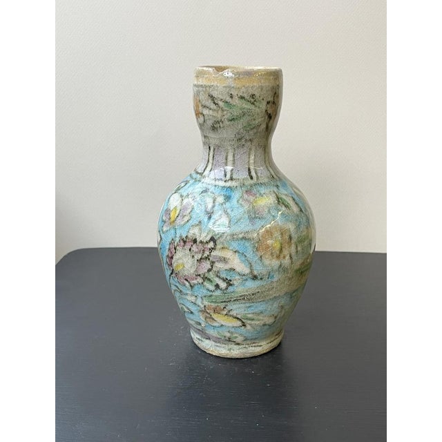 Discover cultural heritage with our white Qajar bottle-vase from Iraq—a stunning piece that reflects rich history and...