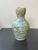 Discover cultural heritage with our white Qajar bottle-vase from Iraq—a stunning piece that reflects rich history and...