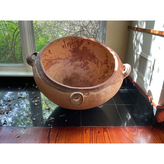 Large handmade antique unglazed terracotta vessel with spout and handles used probably for rainwater collection, later for...