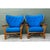 This pair of vintage Heywood Wakefield lounge chairs sets a sculptural, wing-shaped back against a warm bent rattan frame....