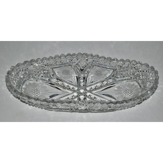 Antique - 1920's Oval Dish with Floral Details. American Brilliant Cut Crystal. The Measurements: 10.75"W x 4.75"D x 2"H....