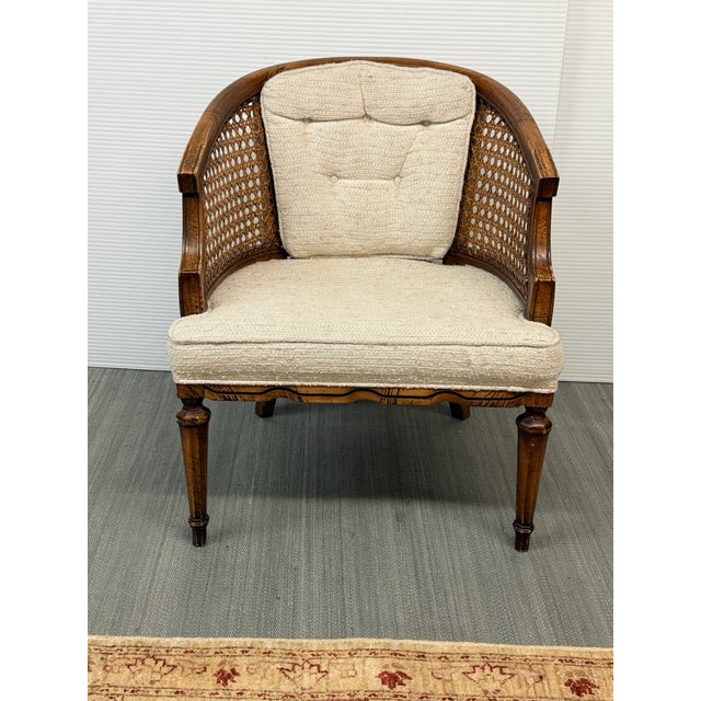Design Plus Gallery presents a Vintage French Louis XVI Style Cane Barrel-Back Bergère Armchair. This distinctive armchair...