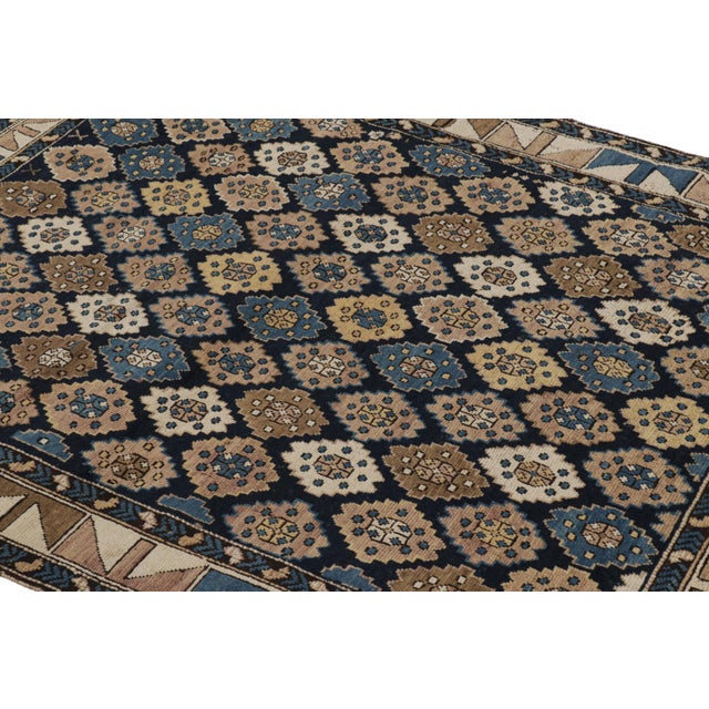 Hand-knotted in wool and originating from Russia circa 1900-1920, this 4x5 antique rug of Kuba provenance is the latest...