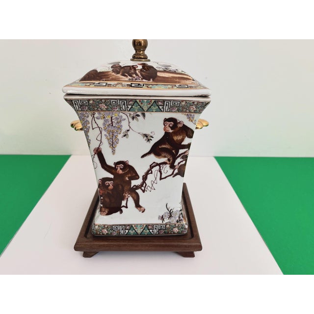 Gorgeous large lidded porcelain jar lamp hand painted with a whimsical family of monkeys climbing flowering vines accented...