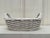 Glossy finished glazed earthenware in white creates a monochromatic flow of color throughout the handmade basket....