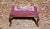 Antique Footstool Ottoman has Needlepoint with Burgundy background and floral bouquet center motif. Solid Mahogany base in...