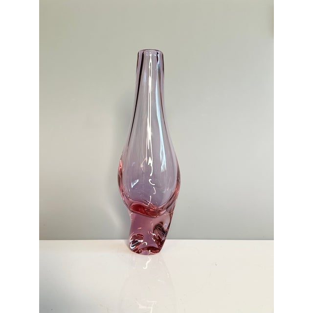 An elegant, sculptural glass vase made of heavy Bohemian alexandrite glass with a softly rounded, twisted silhouette and a...