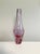 An elegant, sculptural glass vase made of heavy Bohemian alexandrite glass with a softly rounded, twisted silhouette and a...