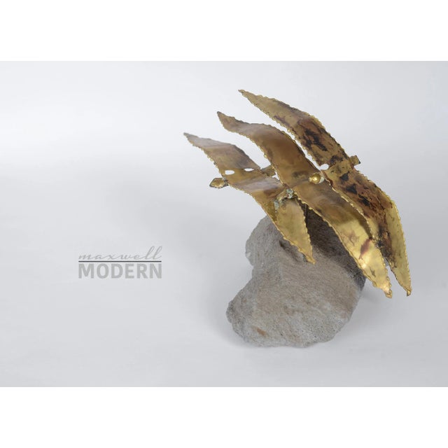 Beautiful vintage brass sculpture of three seagulls flying in unison with a natural rock stand. Top bird is connected to...