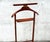 Elegant Italian valet stand by Fratelli Reguitti, crafted in solid wood with brass accents and classic mid-century...