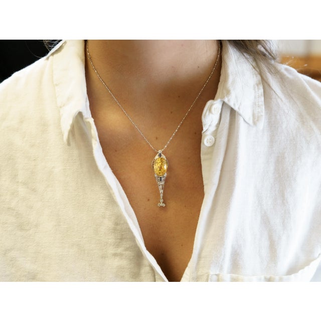 Antique Art Deco Era Platinum, Yellow Sapphire, and Diamond Pendant. This antique art deco pendant features a, non-heated...