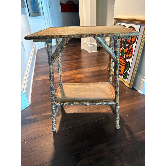 Late 19th century tortoise bamboo side table from France. The top is surrounded by a band of bamboo molding. The table is...