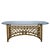 An organic bamboo and rattan dining table, its natural poles and woven construction full of handcrafted, free-form...