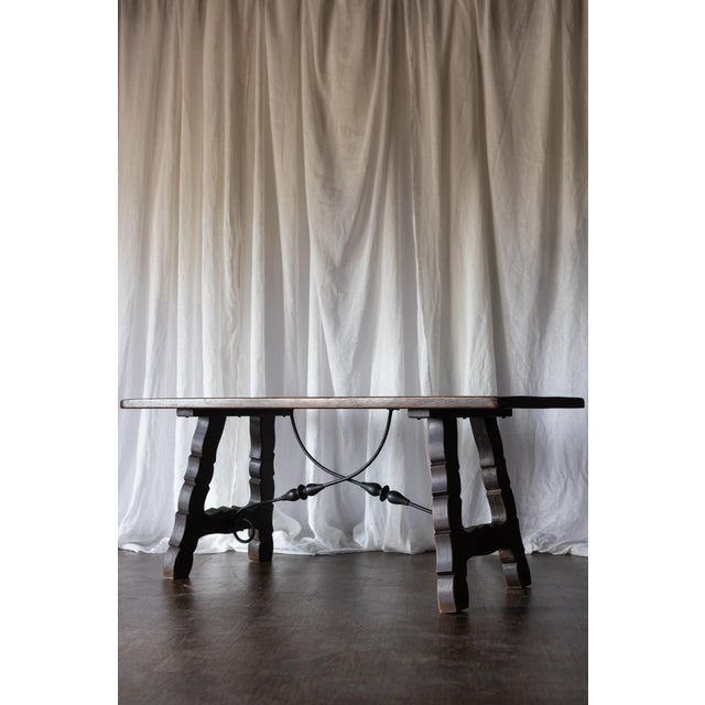 This late 1800s Catalan-style trestle table from France features distinctive lyre-shaped legs connected by a hand-forged...