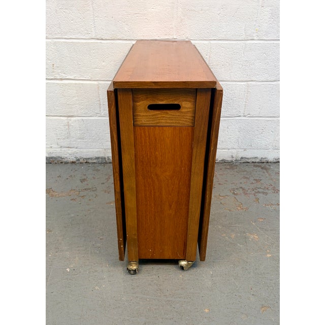 Bring mid-century charm and smart functionality to your home with this Romanian Drop Leaf Hide-A-Way Table and four...