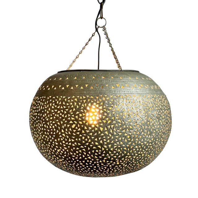 Vintage Moroccan nickel bowl pendant light. Hand cut perforated intricate design pattern which emits a beautiful glowing...