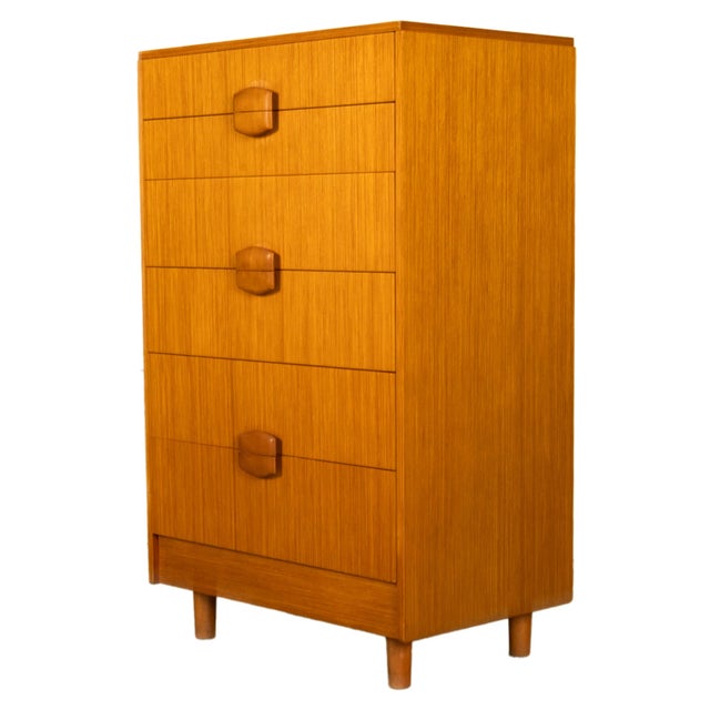 A good Mid Century Modern teak tall Danish style chest of drawers/ dresser, circa 1960. This very stylish dresser is in...