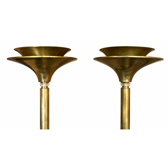 Pair of vintage Art Deco style brass torchiere floor lamps from 70's. Designed with a distinctive flared, chalice-like...