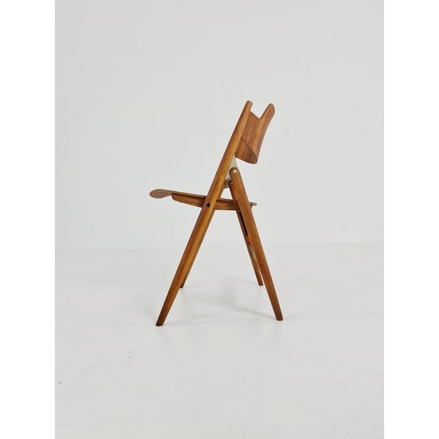 Austrian folding walnut chair model SE18 by Egon Eiermann for Wilde & Spieth Designer: Egon Eiermann Manufacturer: Wilde &...