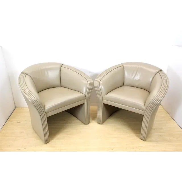 Pair of leather armchairs by Patrician Furniture Co. Soft, supple taupe colored leather in a modern form with rolled edges...