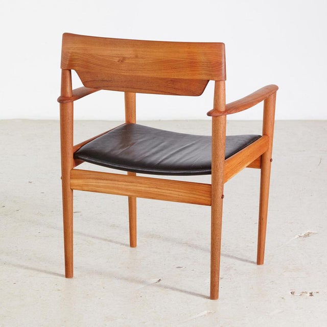 Comfy teak Danish armchair with black leather seat in restored condition, designed by Grete Jalk for P. Jeppesen, 1960