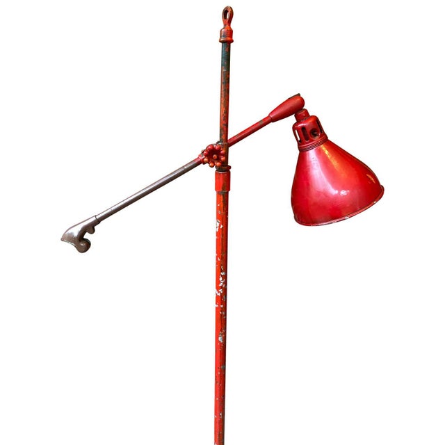 Large adjustable industrial floor lamp featuring the original base. The iron lamp is painted in red and signed O. C. WHITE...