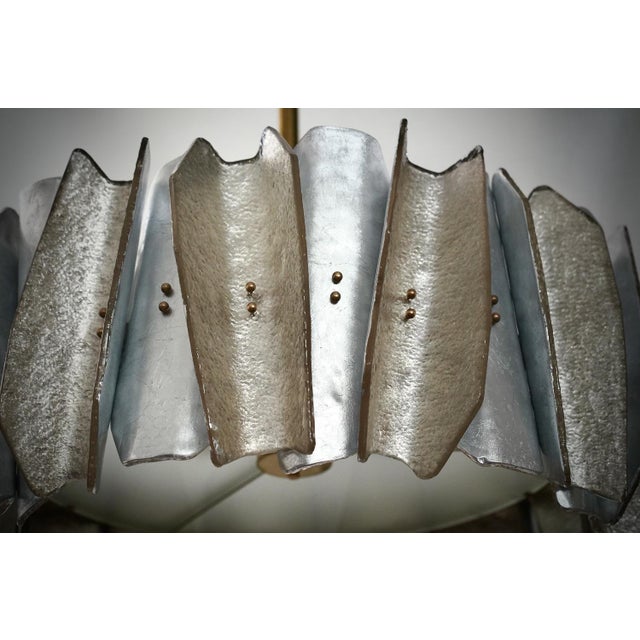 Fantastic round chandelier in Murano glass and polished brass. Note the shape of the silver and bronze colored Murano...