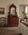 This antique wooden dresser features an impressive arched mirror, sculpted drawer pulls, three generous drawers, and a...