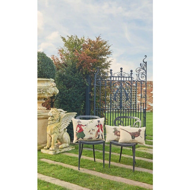 Lady Fenella Fox, wearing her Edwardian side saddle habit, elegantly anticipates the call to hounds by summoning her groom...