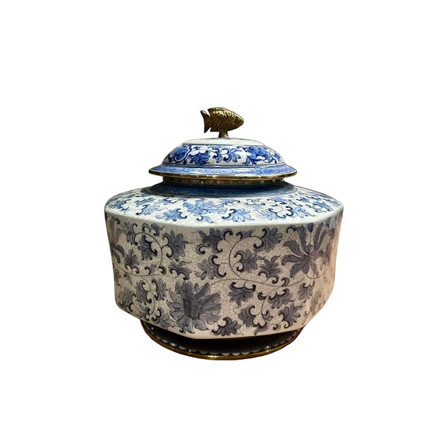 Maitland-Smith blue and white octagonal lidded jar featuring a delicate brass fish. This elegant jar features lovely blue...