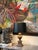 Neoclassical-style faux wood urn table lamp. Detailed carved/cast resin baluster pedestal and a contrasting opaque black...