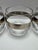 Set of four vintage mid-century lowball glasses featuring a wide silver-tone decorative band with classical etched-style...