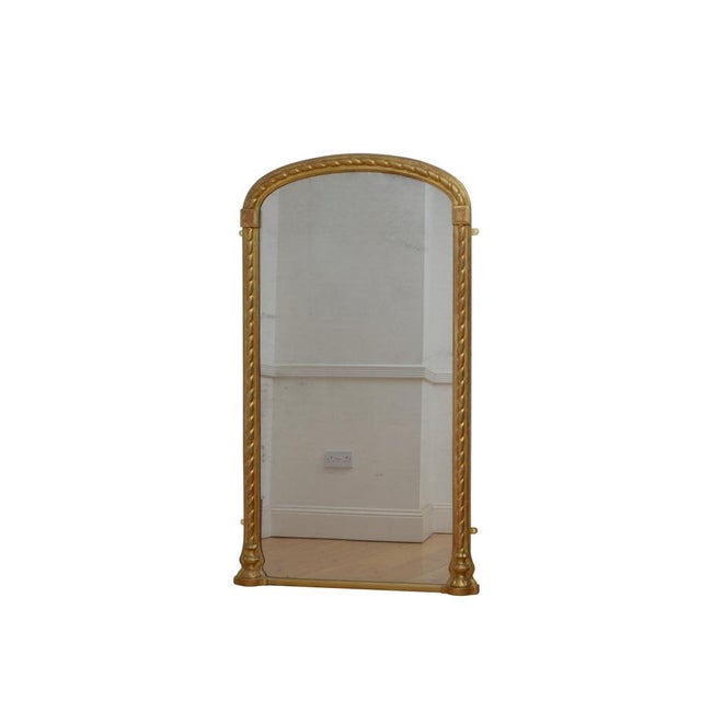 A good 19th century gilded pier mirror or wall mirror, having original glass with some foxing in arched frame with moulded...