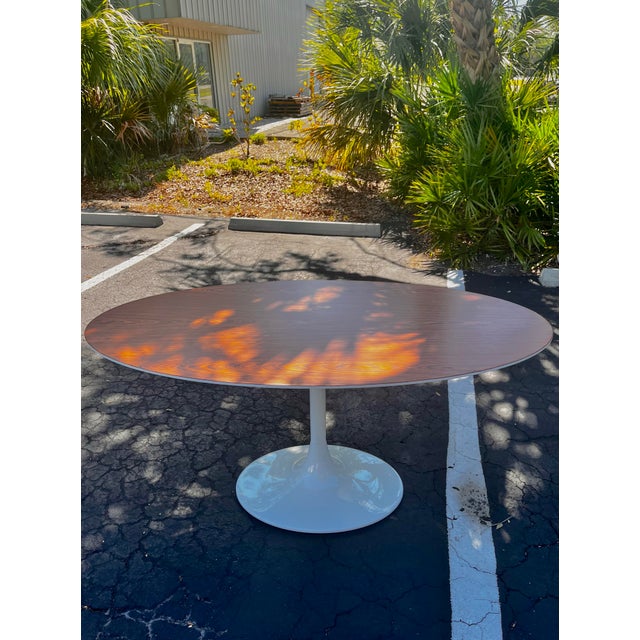 Oval tulip dining or conference table with rosewood. In the style of Eero Saarinen for Knoll. Complete restoration. See...