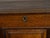 An English Georgian period oak mule chest from the early 19th century, with lift top, three drawers and brass hardware....