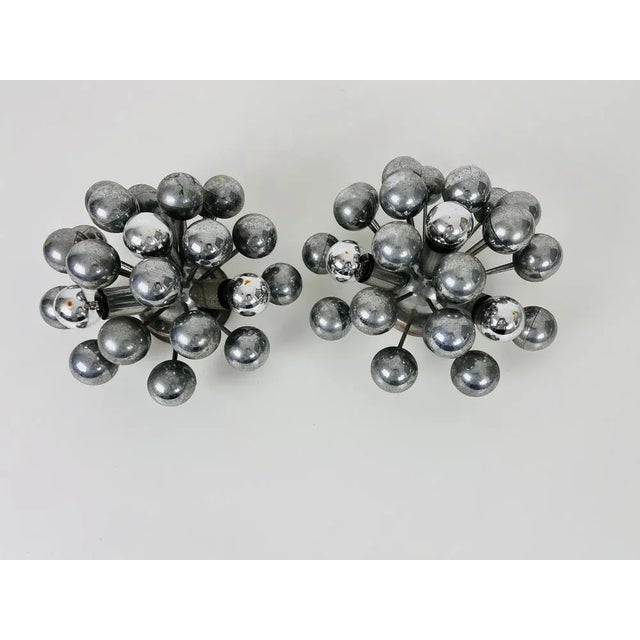 A pair of chrome flush mounts of wall lamps made by cosack in the 1960s. It is fascinating with its space age design and...