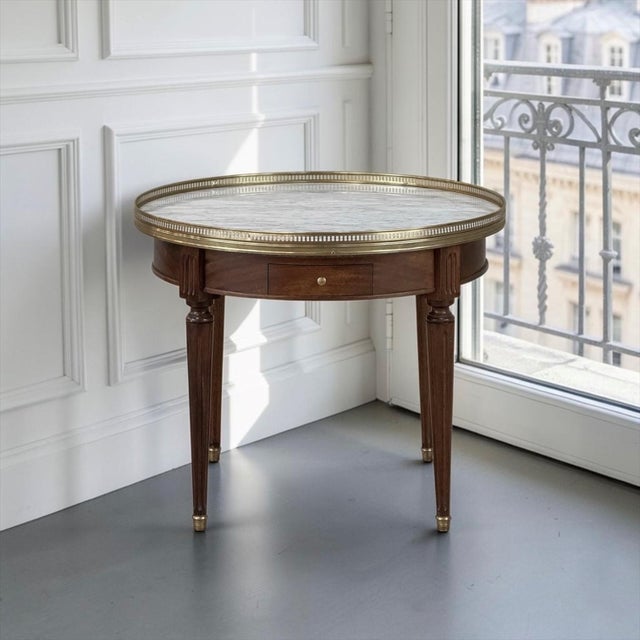 Elegant proportions and refined neoclassical detailing distinguish this Antique French Louis XVI Mahogany Marble Top...