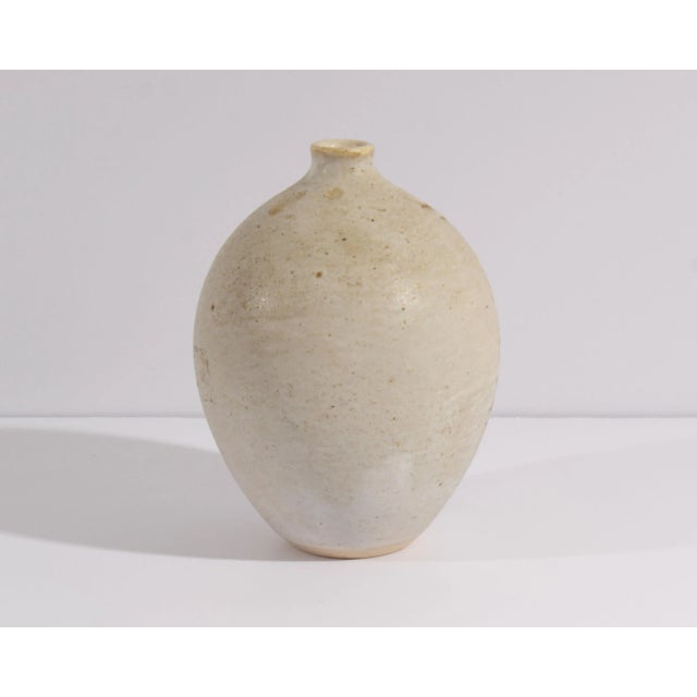 A pottery vase by Andersen Design. Marked "AD" to the underside, this oval vase features a tree design to the front. The...