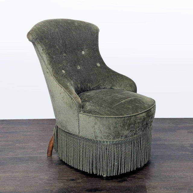 This elegant lounge chair features a soft green velvet upholstery with a comfortable, curved backrest and button-tufted...