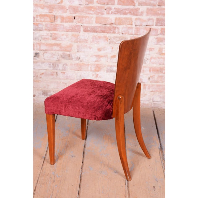 This magnificent and characteristically shaped set of twelve Art Deco chairs, dating from the 1940s in Czechoslovakia,...