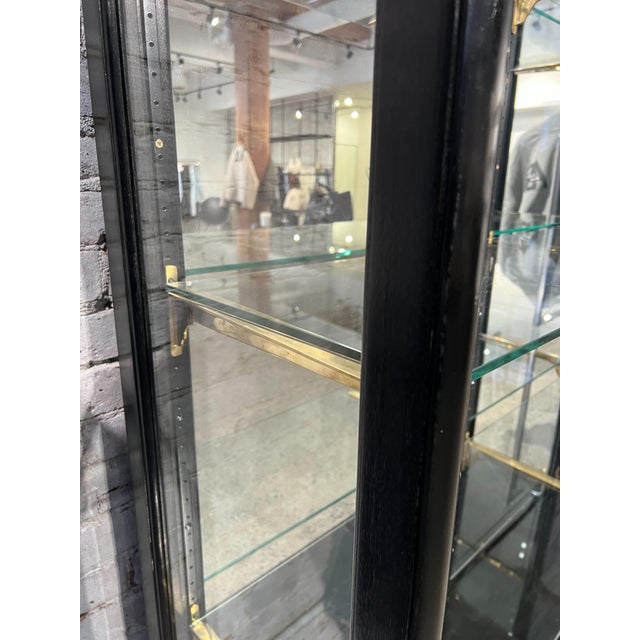 Beautiful large black display cabinet with glass shelving and glass sides, designed to showcase your favorite pieces in a...