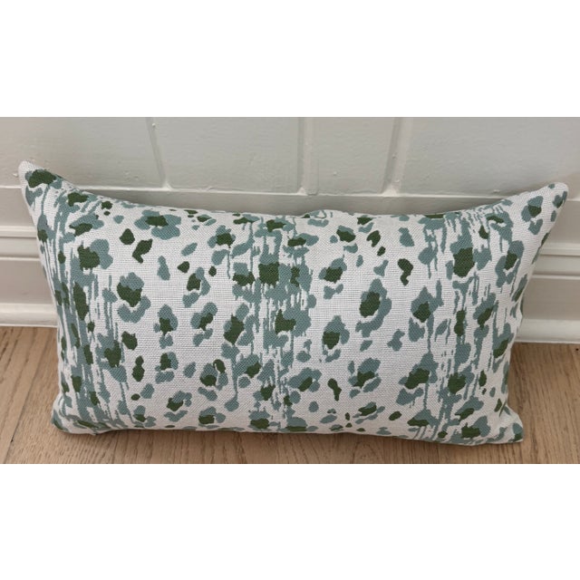 One 12" H x 21" W outdoor pillow in CW Stockwell's 'Ocelot' in Color 'Seadrift' - a blue and green leopard pattern on...