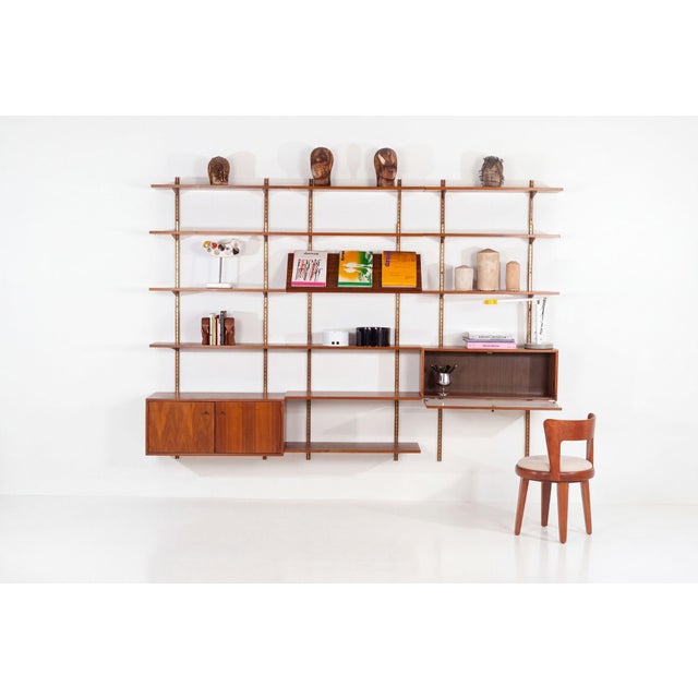 Edward Wormley for Dunbar Three-Bay Walnut & Brass Shelving System, 1952 Wall-mounted modular shelving system designed by...