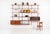 Edward Wormley for Dunbar Three-Bay Walnut & Brass Shelving System, 1952 Wall-mounted modular shelving system designed by...