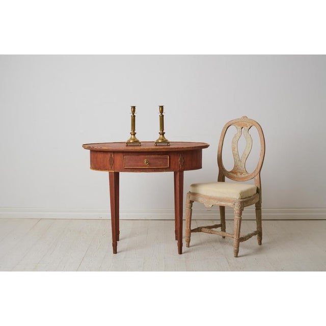 Classic gustavian side table from the late 1700s. The table has a classic straight shape with an oval table top and...