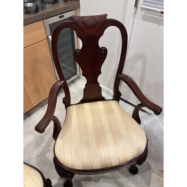 This set of Queen Anne carved solid mahogany dining chairs was made by Baker Furniture Company (see last 2 photos). They...