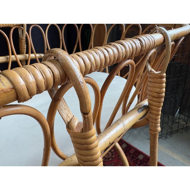 Charming vintage rattan cradle from the 1960s-1970s, with an airy and organic design typical of the period. This piece...