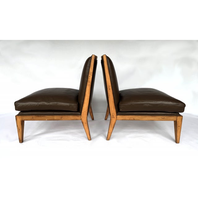 This pair of Swaim modern armless slipper chairs by Swaim Upholstery features brown leather upholstery and oak frames. The...