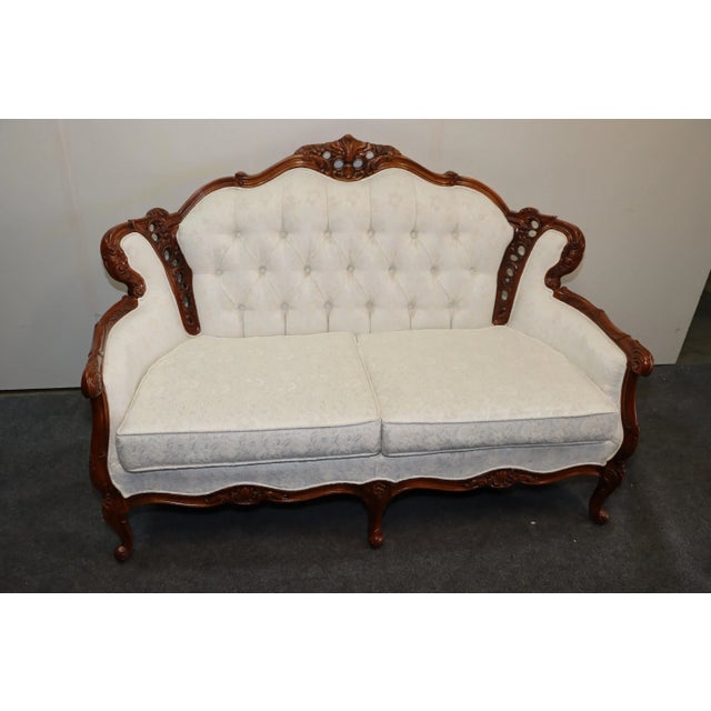 Louis XV style loveseat , solid cherry frame , detailed carvings throughout, white floral embroidered fabric